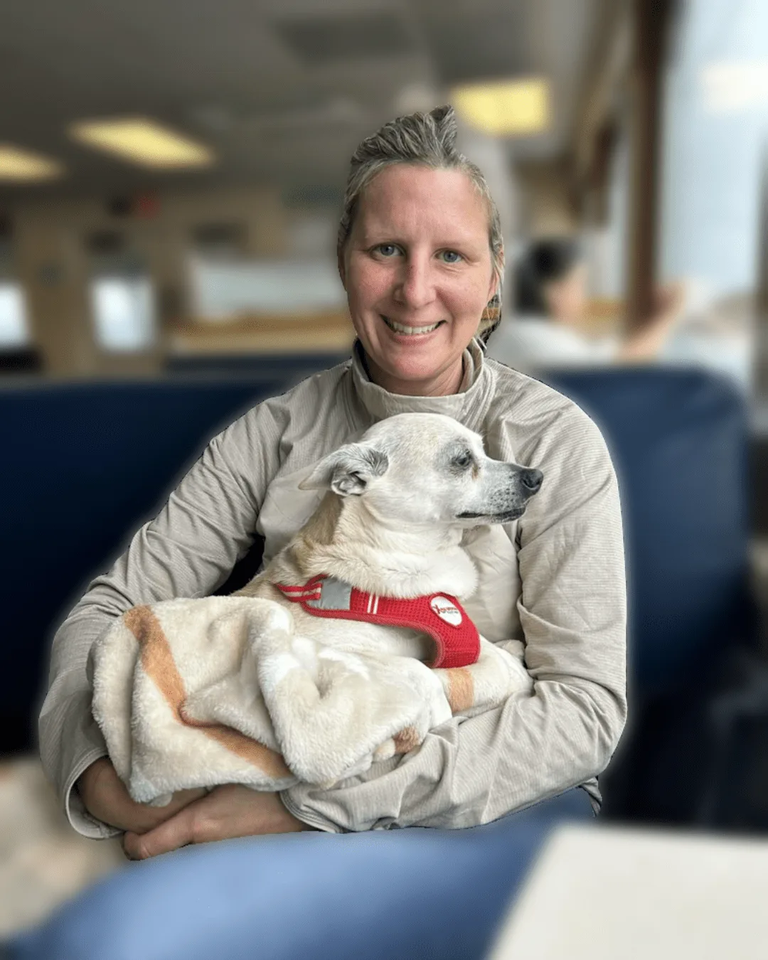 Katie, founder of Pip's Rescue Pack, holding her dog Pip